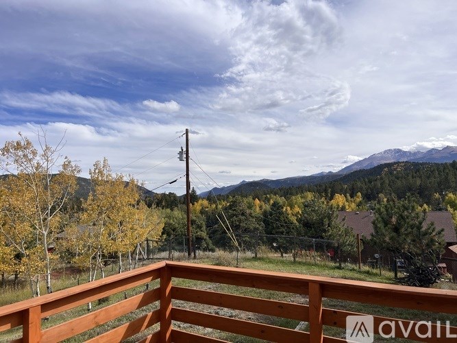 A wooden deck with a mountain view in the background.