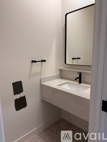 A bathroom with a sink and mirror.
