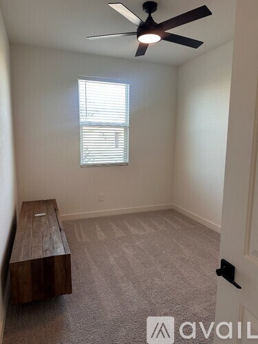 A room with a window and a bench.