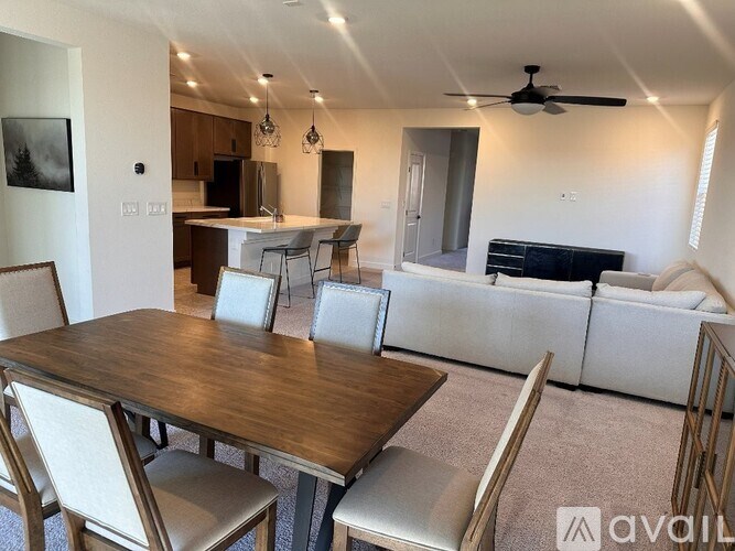 A modern dining room with a wooden table and chairs.