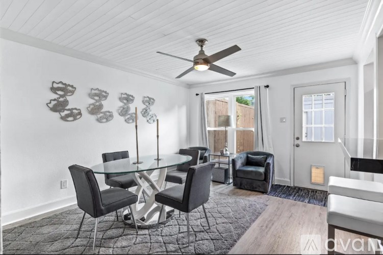 A dining room with a glass table and chairs.