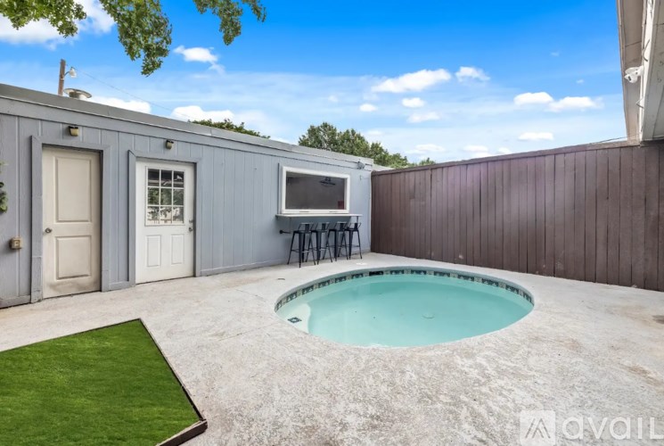 A backyard with a pool and a TV.
