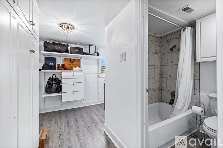 A bathroom with a tub, toilet, and sink.