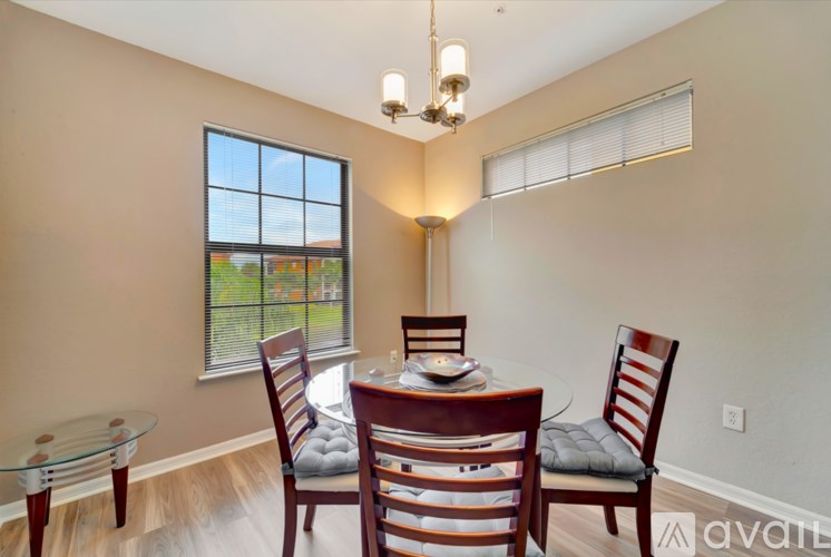 A dining room with a glass table and chairs.
