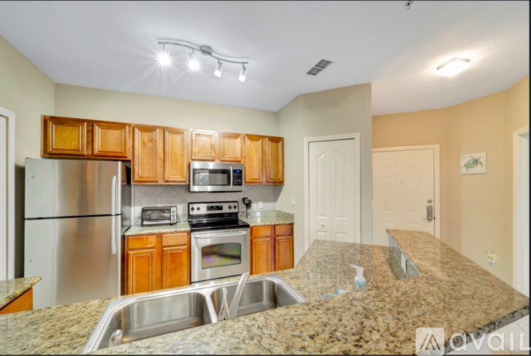 A kitchen with granite countertops and stainless steel appliances.