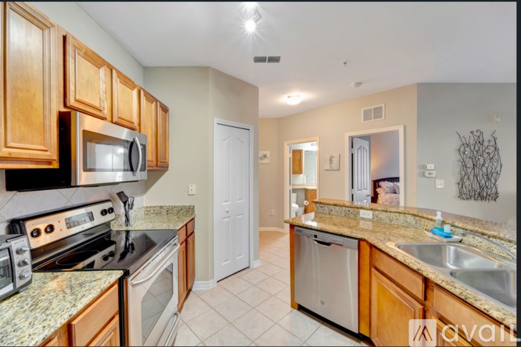 A kitchen with granite countertops and wooden cabinets.