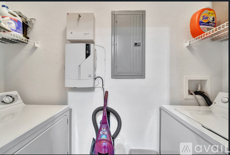 A small laundry room with a washer and dryer.