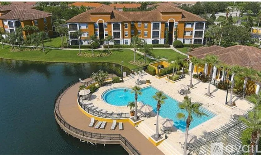 A resort with a pool and a building in the background.