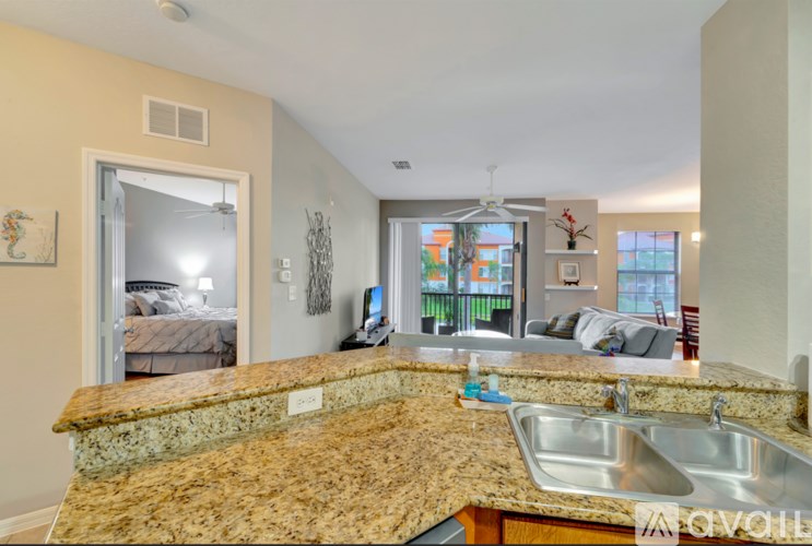 A kitchen with granite countertops and a stainless steel sink.