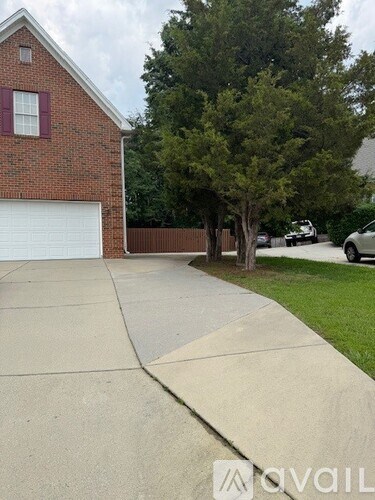 A house with a red brick exterior and a white garage door.