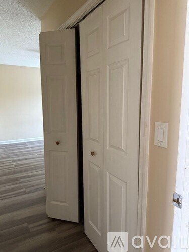 A white door is closed and another is open.