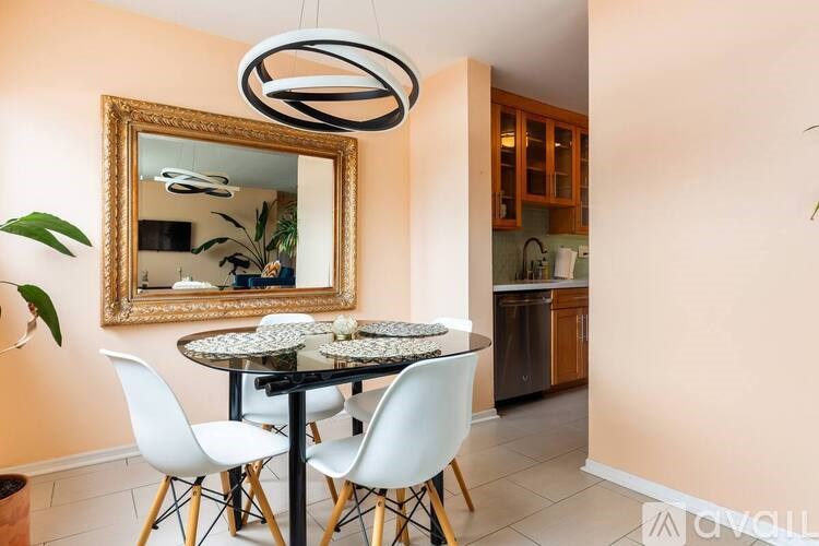 A dining room with a round table and chairs.