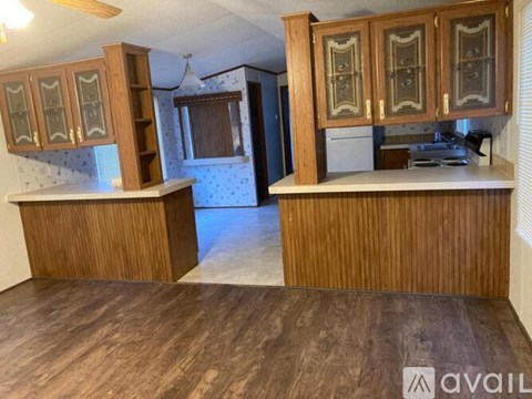 A kitchen with wooden cabinets and a counter.