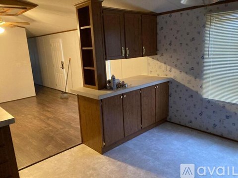 A kitchen with wooden cabinets and a countertop.
