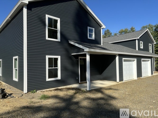 A two-story house with a garage is available for sale.