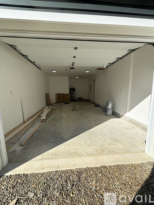 A large empty room with a carpeted floor and white walls.