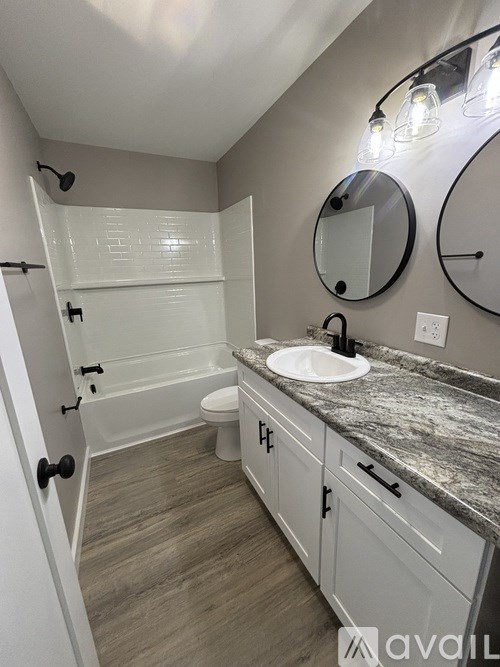 A bathroom with a sink, mirror, and toilet.