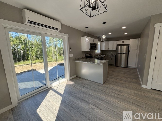 A modern kitchen with a large island and stainless steel appliances.