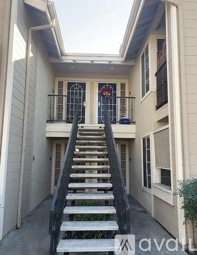 A staircase leads up to a door with a glass window.