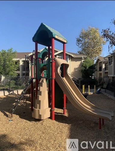 A playground with a slide and a green roof.