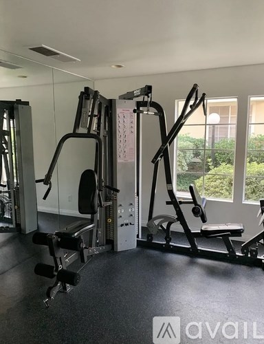A gym with a variety of equipment including a leg press machine.