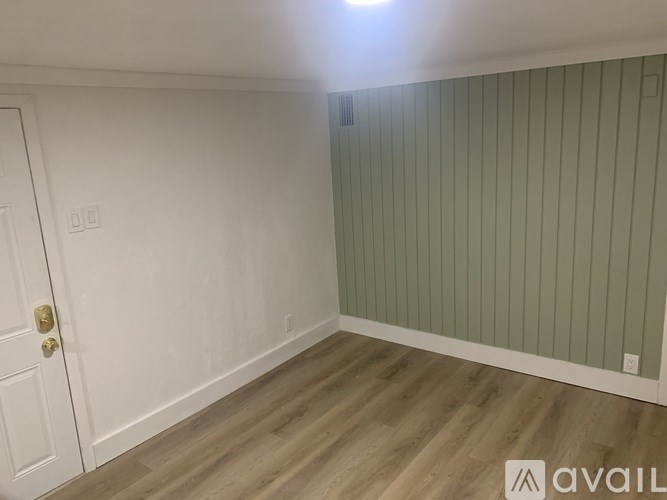 A room with a door and a light on the ceiling.