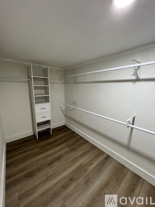 A room with a ladder and drawers.