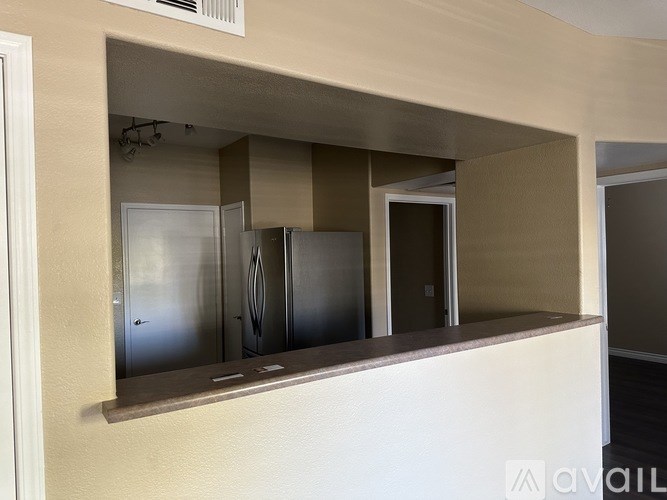 A kitchen with a refrigerator, oven, and microwave.