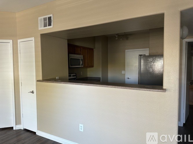 A kitchen area with a microwave and a refrigerator.