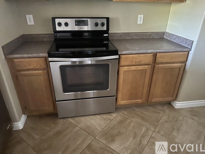 A modern kitchen with a stainless steel oven and microwave.
