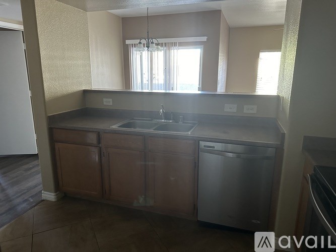 A kitchen with a sink and a dishwasher.