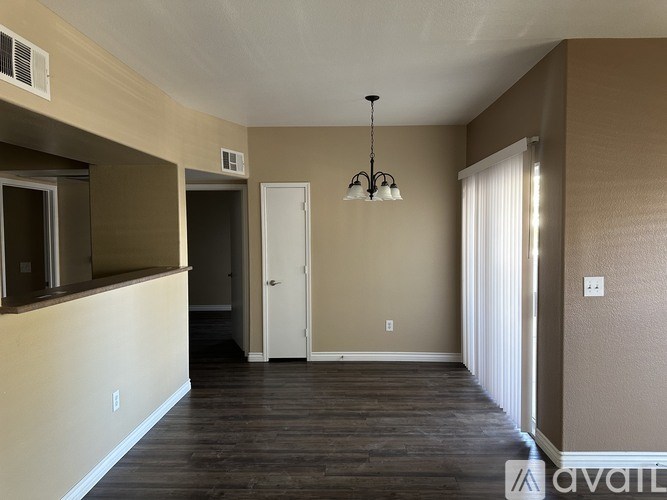 A room with a chandelier and a door is available.