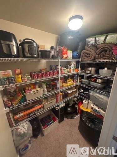 A kitchen pantry with many shelves filled with food and kitchen supplies.