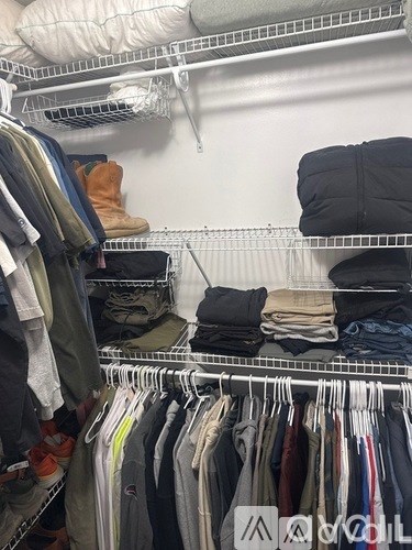 A closet full of clothes and shoes.
