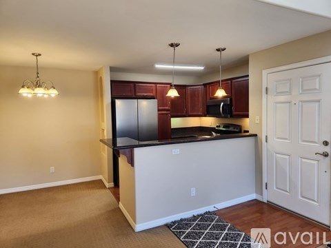 A kitchen with brown cabinets and a black countertop.
