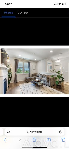 A 3D tour of a modern living room with a sofa, coffee table, and potted plants.