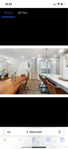 A 3D tour of a room with a dining table and chairs.