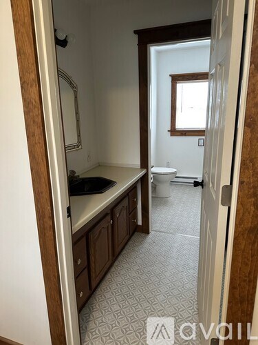 A bathroom with a toilet and sink.