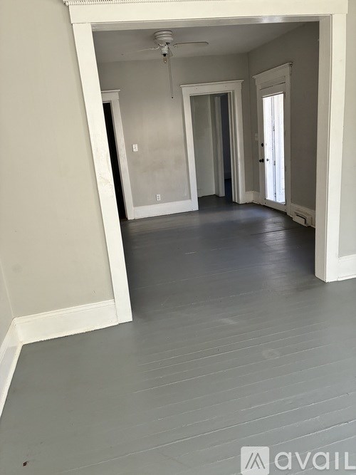 A room with a grey floor and white walls.