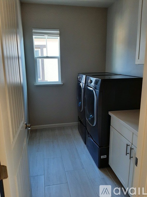 A small laundry room with a washer and dryer.