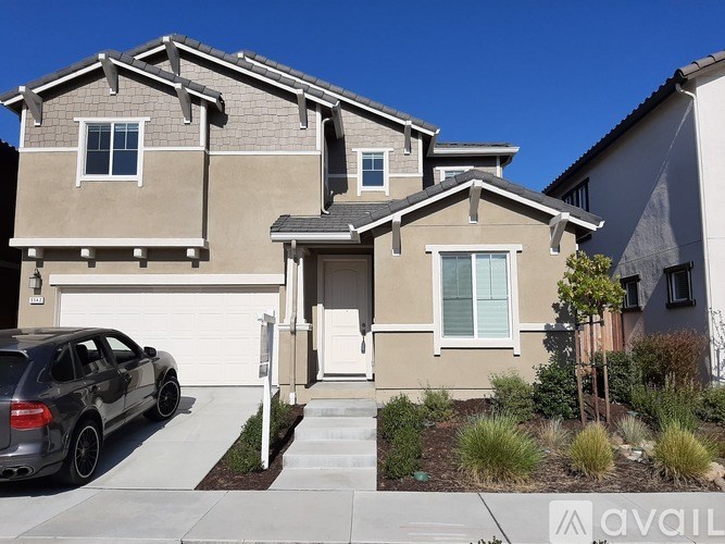 A house with a car parked in front of it.