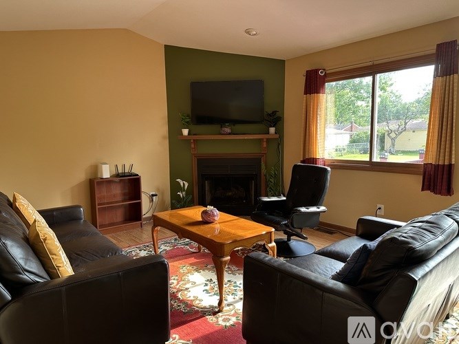 A living room with a fireplace and a television.