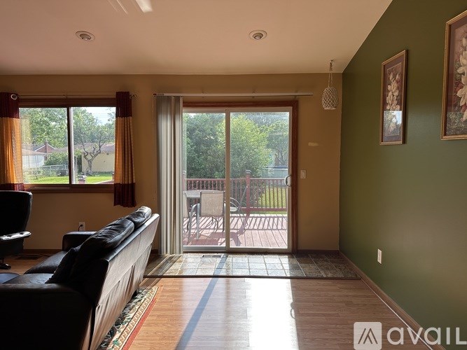 A living room with a couch and sliding glass doors leading to a patio.