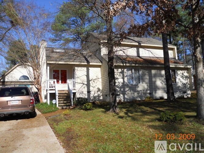 A house with a car parked in front of it.