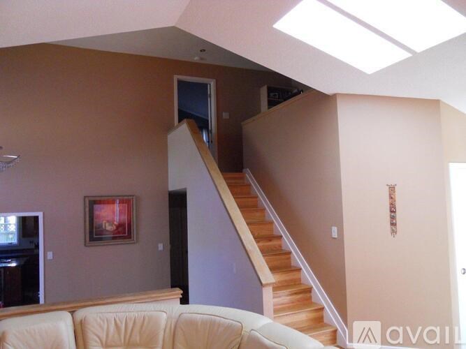 A living room with a couch and a staircase.