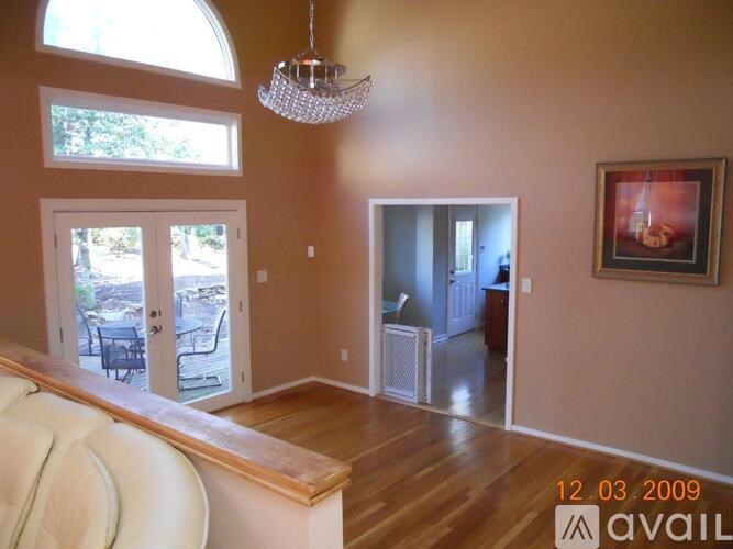 A living room with a couch and a chandelier.