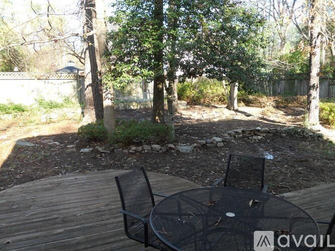 A backyard with a table and chairs.