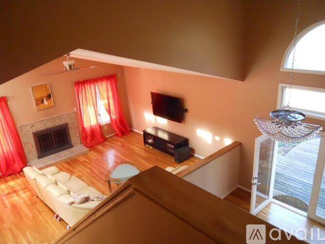 A living room with a fireplace and a television.