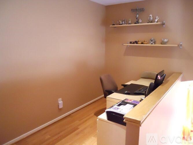 A room with a desk and a chair.