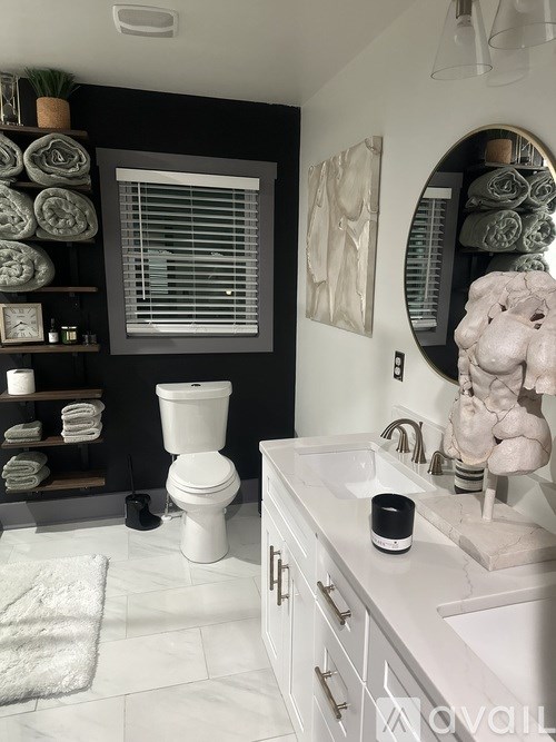 A bathroom with a white toilet and a white sink.